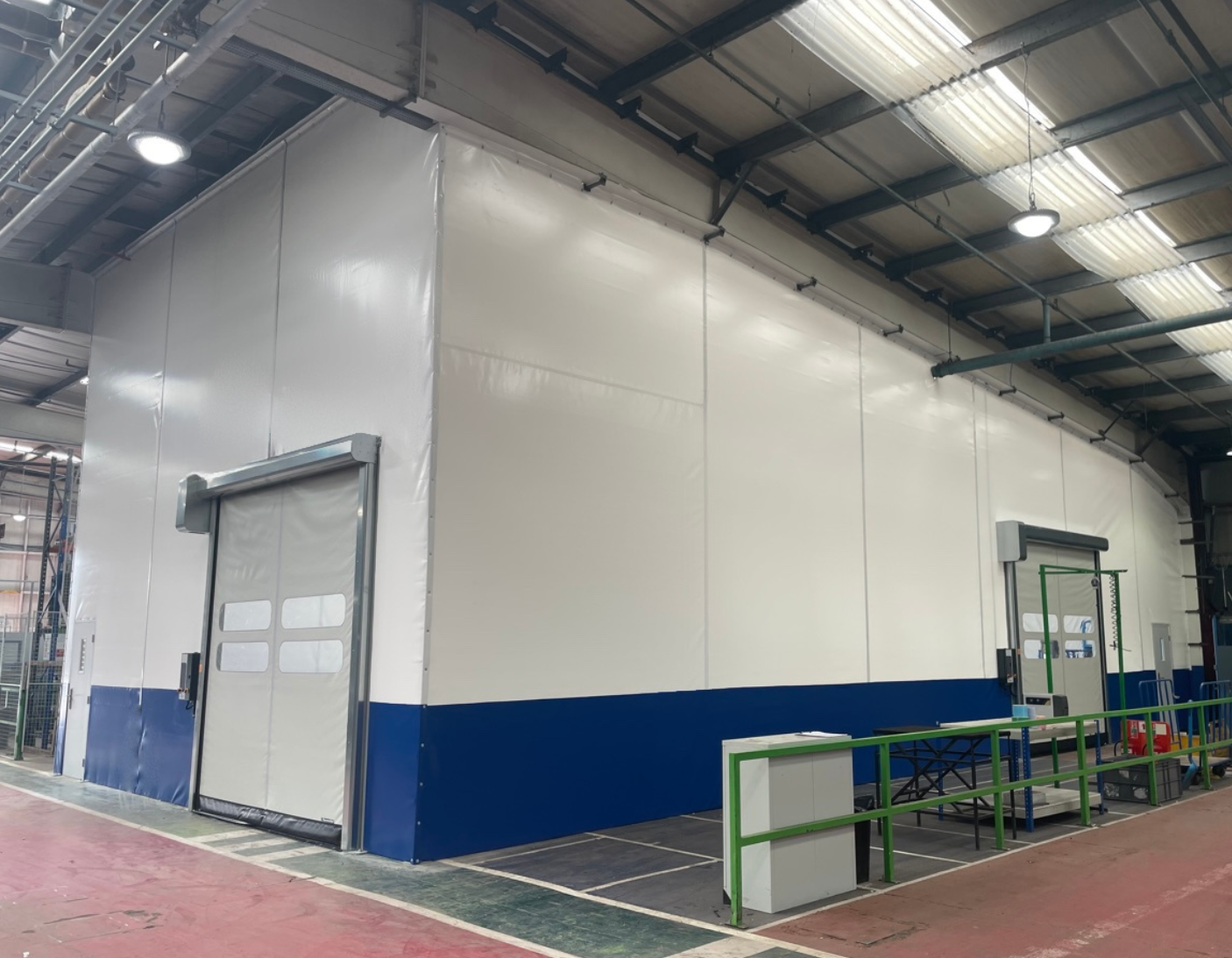 Industrial curtains installed inside a manufacturing facility to control dust, improve workplace safety, and support HSE compliance.