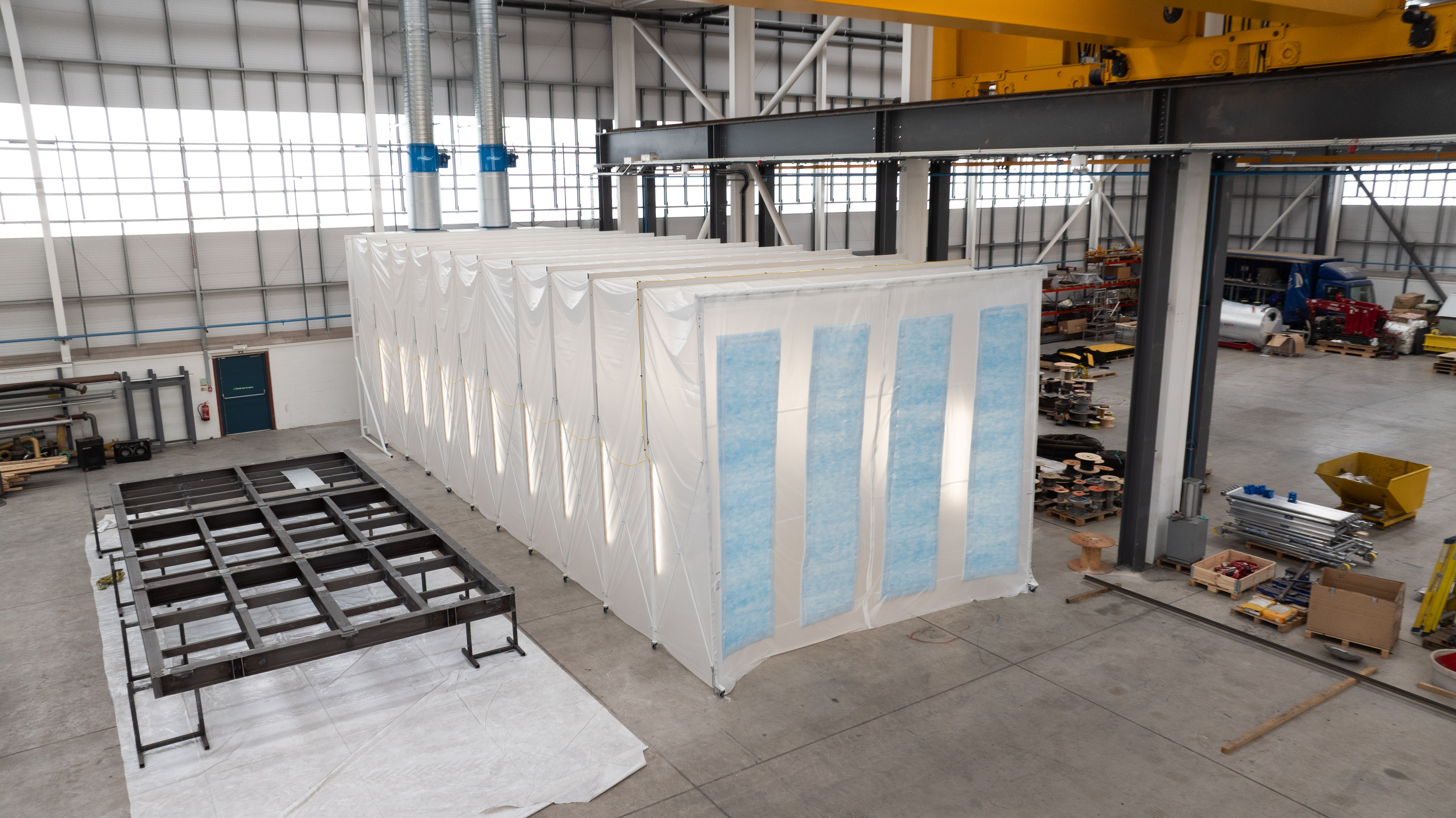 Retractable spray booth designed to create a flexible spraying area while saving workshop floor space.